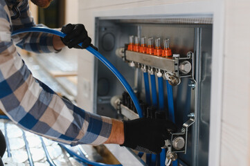 Water underfloor heating systems installation, work in progress on construction site for a modular...