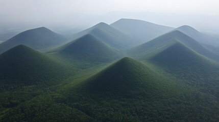 Fototapeta premium Aerial View of Lush Green Pyramid Mountains