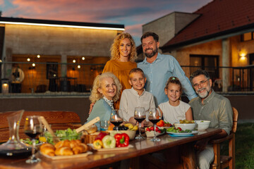 Family enjoying outdoor dinner together at home