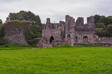 A castle with a large grassy field in front of it