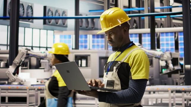 Industry 4.0 plant engineer following maintenance procedures to mend bugs. Smart factory professional analyzing data on laptop to predict production lines and robotic arms failures, camera A