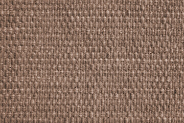 Texture of brown natural fabric with large weaving. Surface, structure of upholstery or carpet material, cloth background close up.