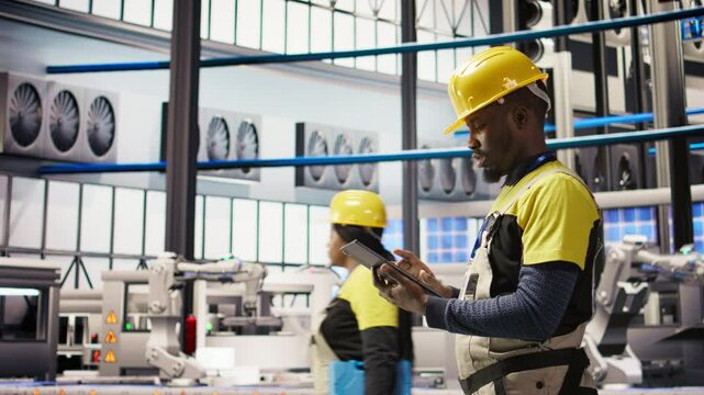 Smart factory mechanic testing automated systems, doing preventive maintenance. Industry 4.0 plant repairman inspecting equipment to identify and service glitches, camera A