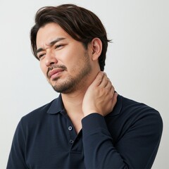 Obraz premium Asian man is experiencing pain in his neck with his hands holding his neck