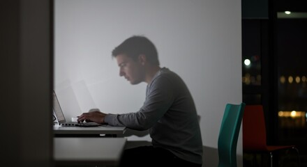 Man Working on Laptop at Night - Photo