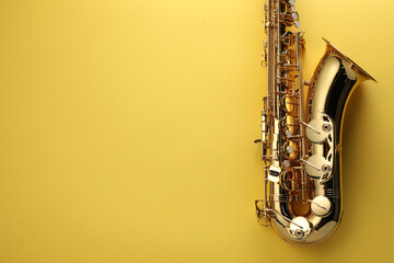 Jazz. One saxophone on yellow background, top view. Space for text