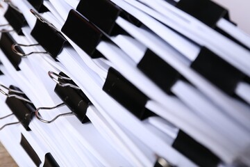 Binder clips with sheets of paper, closeup