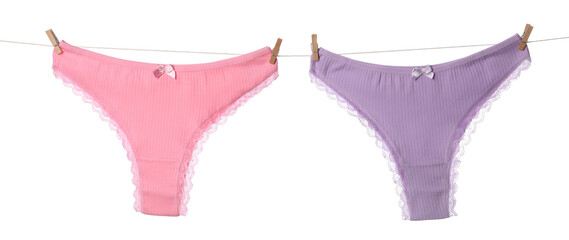 Beautiful panties on clothes line against white background