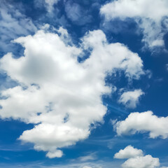 Fluffy White Clouds Floating in a Vibrant Blue Sky