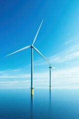 Fototapeta premium Two wind turbines are standing in the ocean, with the ocean water below them