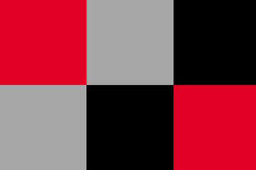 Colorful geometric pattern featuring contrasting red, black, and gray squares in a modern design setting