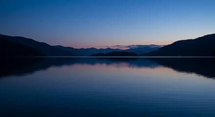 Serene Lake Reflecting Twilight Sky with Deep Blues and Purples Featuring Gentle Ripples and Subtle Reflections