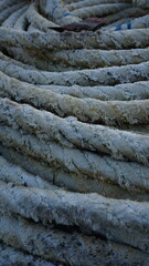 Close-up of coiled, aged ropes outdoors