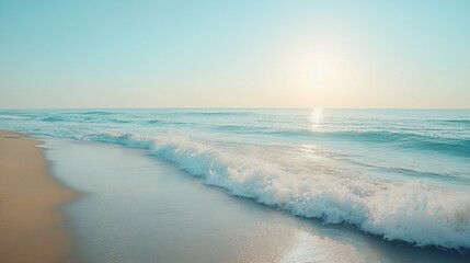 Obraz premium Serenity at Sunrise: Gentle waves meeting sandy shore in a tranquil coastal scene