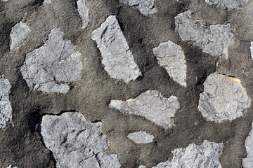 Grey gray stone and mortar wall close-up abstract textured background