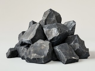 Pile of dark gray rocks.  A collection of unevenly sized, dark gray stones, seemingly piled on top of each other
