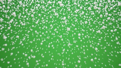 Fototapeta premium A continuous cascade of delicate snow particles descends against a vibrant green background