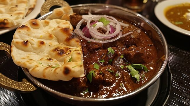Nihari served with naan and a side of onion salad on a dark textured plate Spicy slow cooked mutton stew a beloved dish from Delhi India overlay cut out on isolated transparent removed background