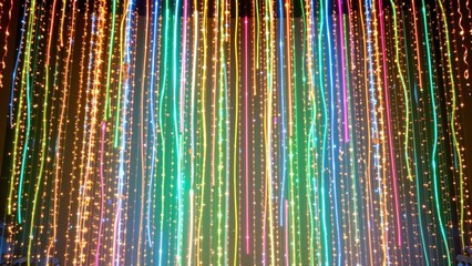 An expansive curtain of closely spaced LED strands forms a shimmering, ethereal background