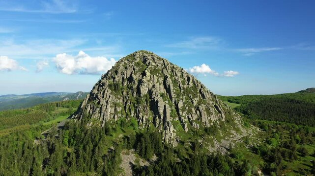 The rocky peak of Mont de Gerbier de Jonc dominates the fields of Europe, France, Ardeche, in summer, on a sunny day.&nbsp;