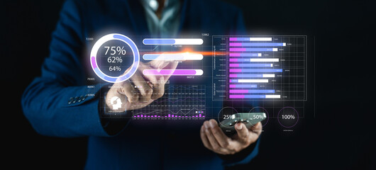 A professional analyzing data through interactive graphics on a digital device, showcasing charts and percentages in a modern business environment.