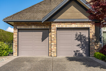 Garage door in luxury house with trees and nice landscape in Spring in Vancouver, Canada, North...