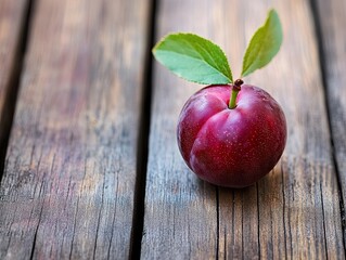 plum isolated on wooden background