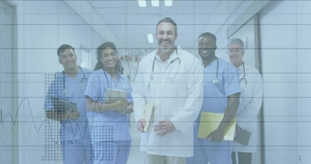 Medical team holding digital tablet, standing in corridor displaying animated financial line charts - Powered by Adobe