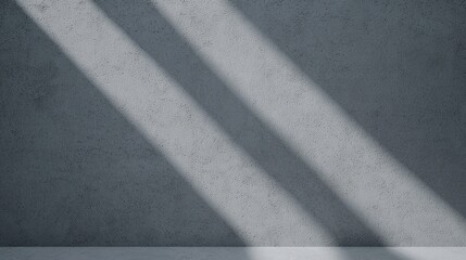 Fototapeta premium A textured gray wall with diagonal shadows cast across it, creating a minimalist and serene atmosphere.