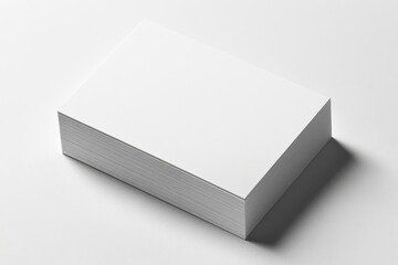 Fototapeta premium A stack of blank white business cards on a plain surface.