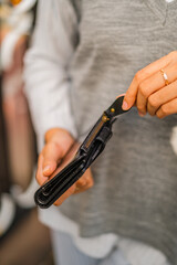 Woman's hand holding black leather purse