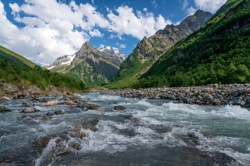 View of the Dombay-Ulgen gorge in the mountains of the North Caucasus near the village of Dombay on a sunny summer day, Karachay-Cherkessia, Russia