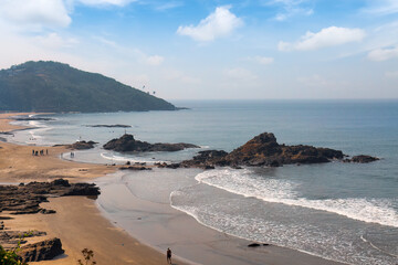 Scenic landscape view of Vagator Beach with rocky shoreline and gentle waves at Anjuna in North...