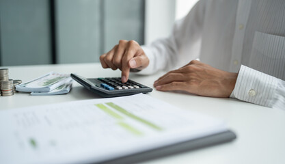 Fototapeta premium Businessman checking bills taxes bank account balance and calculating annual financial statements of company. Accounting Audit Concept