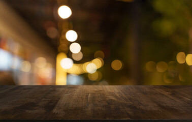 Empty wood table top and blur of restaurant background selective focus product display