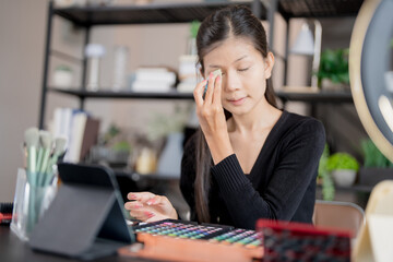 Asia woman beauty influencer makeup artist vlogger live streaming makeup tutorial on smartphone for...