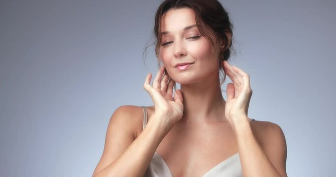 Charming woman plays with her hair and subtly checks her appearance in a beauty-focused scene. High quality visual for cosmetic brands, beauty routines, slow motion edits, and spa content.