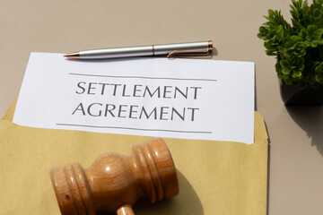 Legal Agreement Signed: Settlement Document with Gavel on Wooden Desk