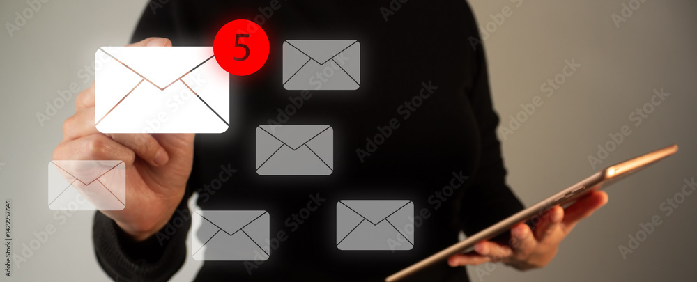 Poster concept of spam email. person's hand holding a digital tablet while pointing at an email icon with a