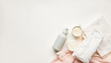 Flat lay of baby skincare products with towels