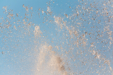 Splashes and jets of water against light background.