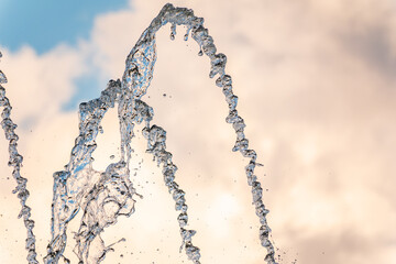 Splashes and jets of water against light background.