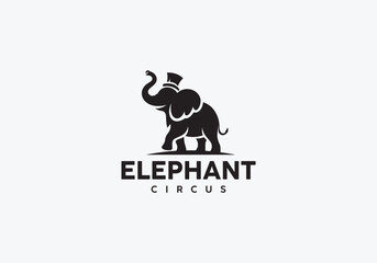 Silhouette of a circus elephant wearing a hat on a white background.
