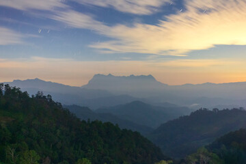 Doi Luang Chiang Dao of photo from Doi Hadubi moving clouds with stars in the night sky beautiful nature at Chiang Mai, Thailand