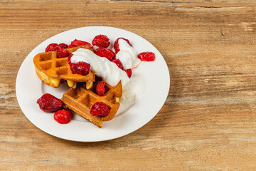 Delicious waffles topped with raspberries and cream