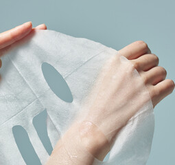 A woman's hand on a mask sheet