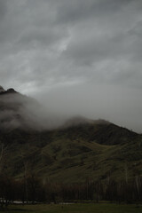 high mountains in fog, shot at the foot of the mountain