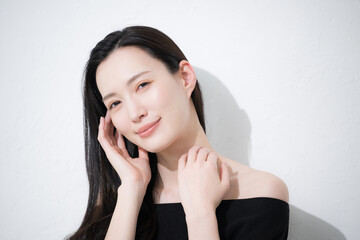 黒髪が美しい若い女性の艶と素肌感が美しい手を添えるビューティーイメージのカメラ目線　色っぽい美しい表情