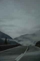 wet asphalt in the distance mountains in the clouds