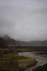 Foggy landscape with river in mountains